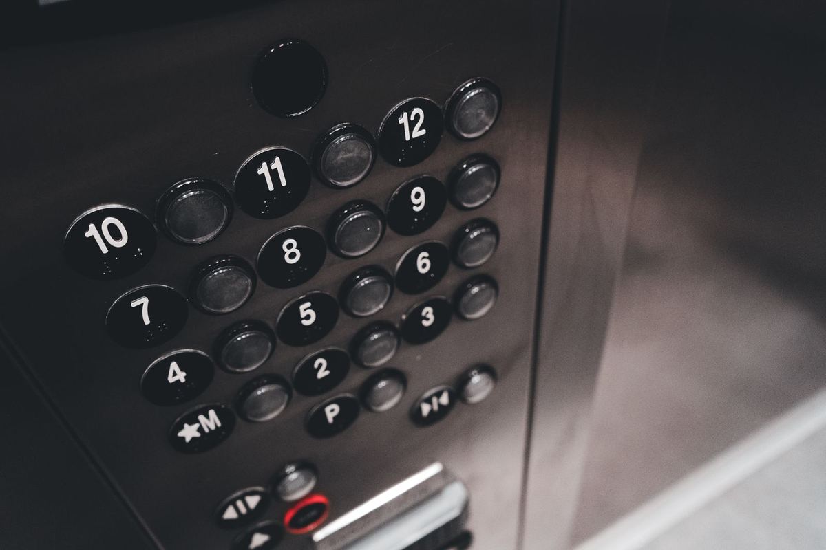 Stainless steel elevator car operating panel with laser-cut button holes